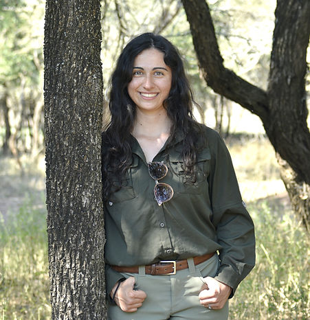 Monica Lasky standing beside a tree in the field